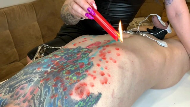 Hot Wax Games! Dominatrix pours wax on slave's body