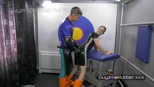 Two guys in tight shiny rubber & orange boots; arse fingering, jerking each other, dildos, rimming
