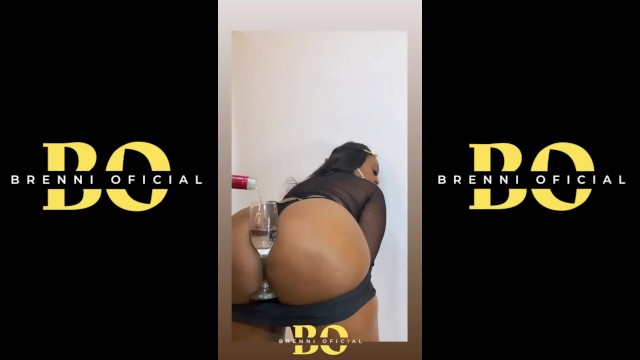 Latina with a glass of wine in her ass